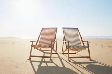Beach chairs in the sand - summer PTO concept 