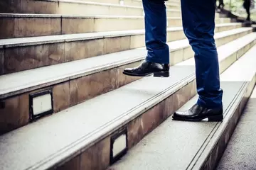 Upskilling reskilling advancing career walking up stairs concept